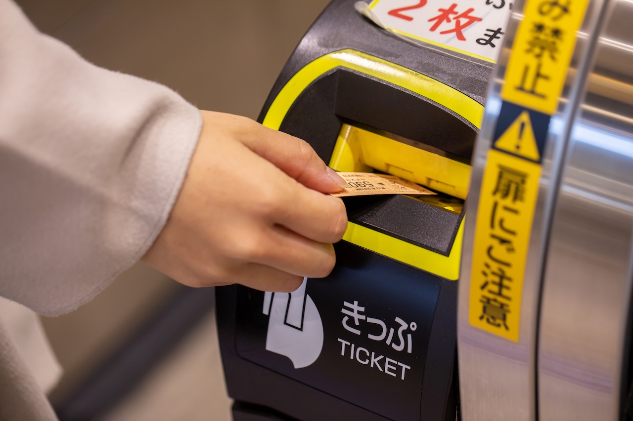 自動改札機に切符を入れるところ